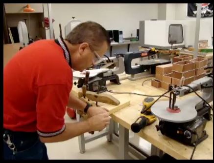 IN ACTION PHOTOGRAPH of using scroll saw
